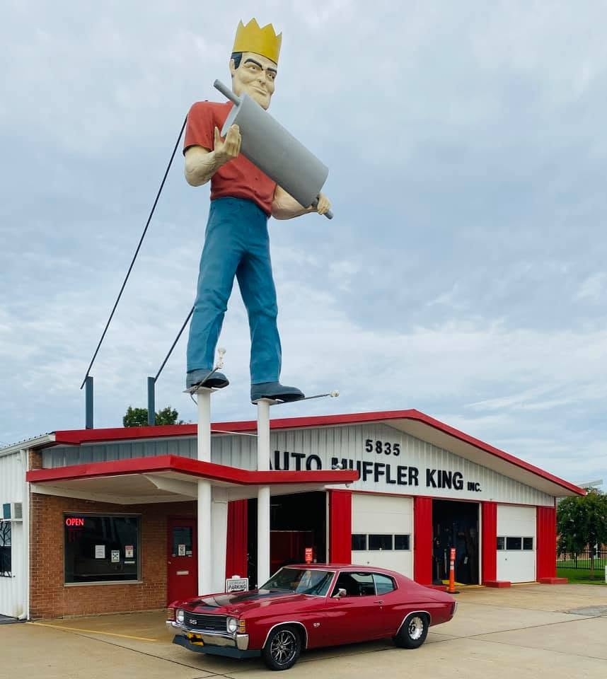 auto muffler king outside view of automuffler king with a red car out front
